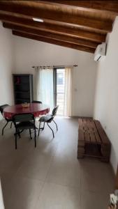 a living room with a table and chairs and a couch at Villa Simona in Santa Rosa de Calamuchita