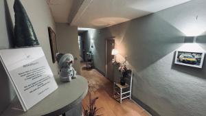 a teddy bear sitting on a table in a hallway at Terracqua & Locanda Granducato in Chiusi