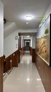 a hallway in a building with a large painting on the wall at Hoteles Perla del Chira in Piura