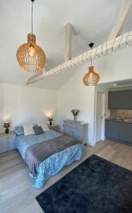 a bedroom with a bed and two lights at The Garden Room in Henley on Thames