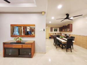 a dining room and kitchen with a table and chairs at ipoh 5min to town centre 92bungalow 5br5bath19pax in Ipoh