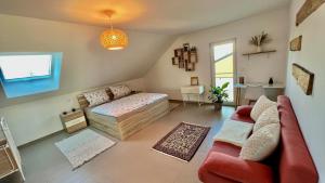 a living room with a bed and a couch at La Dolce Vita Apartment in Kehl am Rhein