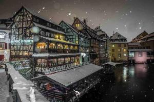 a building covered in snow in a city at La Dolce Vita Apartment in Kehl am Rhein