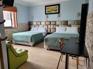 Postel nebo postele na pokoji v ubytování Hotel Tinkus Inn