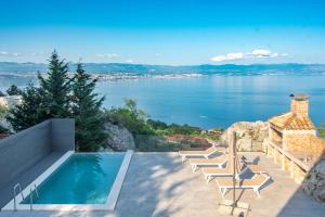 a swimming pool with a view of the water at Villa Zgodić in Lovran