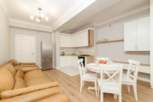 a living room with a couch and a table at City Walk Apartment & MiRent in Chişinău