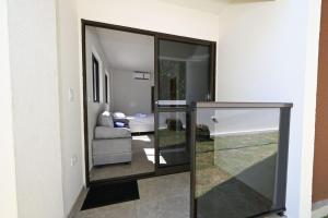 a room with a glass door with a living room at Studio Céu Azul, Pontal de Maracaípe PE in Porto De Galinhas +56 photos