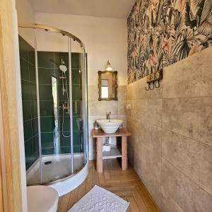 a bathroom with a shower and a sink and a tub at Lawendowy Raj in Pilchowice +85 photos