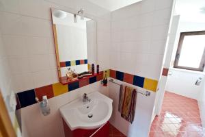 a bathroom with a sink and a mirror at Cherry House in Minturno