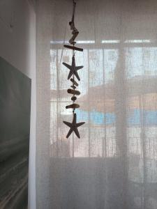 a group of stars hanging from a window at La Casa del Mar in Barbate +7 photos