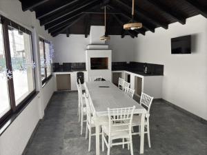 a dining room with a table and white chairs at Casa Lye in Vişeu de Sus +20 photos