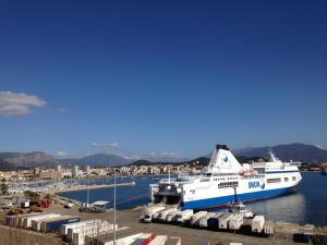 a large cruise ship docked in a harbor at Hotel le Dauphin in Ajaccio