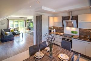 a kitchen and living room with a table and chairs at Villa Zgodić in Lovran