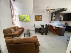 a living room with a couch and a table at Casa Puerta Paraíso in Tepic