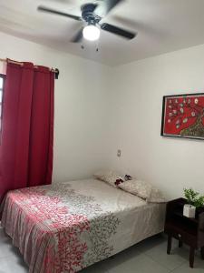 a bedroom with a bed with a ceiling fan at Casa Puerta Paraíso in Tepic