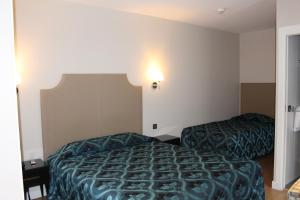 Un ou plusieurs lits dans un hébergement de l'établissement Hotel Montpensier