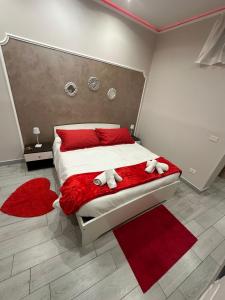 a bedroom with a bed with two stuffed animals on it at House Lurokè in Catania