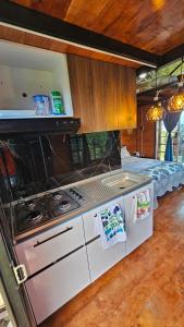 a kitchen with a stove and a bed at Hospedaje Rural Sicaru in Pacho +35 photos