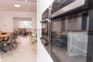 a kitchen with a stove and a dining room at Your Home Away from Home in NWI +17 photos