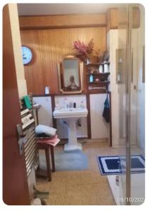 a bathroom with a sink and a mirror at Chambre au calme sur les collines in Nice +4 photos