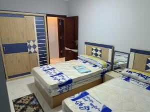 a room with two beds and a mirror at السادس من اكتوبر in 6th Of October