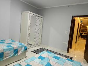 a room with a bed and a glass door at السادس من اكتوبر in 6th Of October