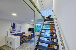 a staircase in a house with a desk and a table at STERK Apartments - idyllisch - modern - stilvoll in Meckenbeuren +27 photos