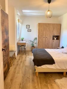 a bedroom with a bed and a table and a desk at Mirador de la Montaña Mágica in El Acebo de San Miguel