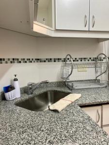 a kitchen sink with a towel on a counter at Alsina - Central Point Apartments in Salta +34 photos