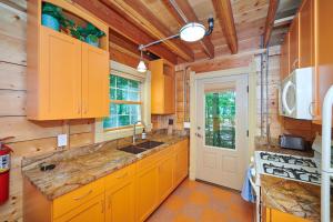 a kitchen with yellow cabinets and a sink at Dollybrook Cottage 1 Pet Friendly Community Pool Groups Welcome in Fennville