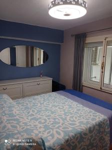 a bedroom with a bed and a large mirror at Apartamento Cool en calpe!centro Turístico y playa in Calpe