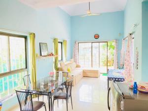 a blue living room with a table and chairs at V Square Villa in Shenwa