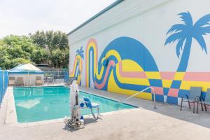 a mural of a swimming pool next to a building at Sandcastle Inn in Tybee Island