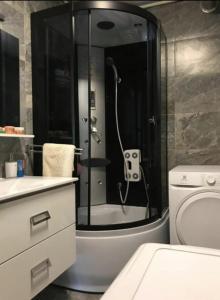 a bathroom with a shower with a toilet and a sink at Slatka sobica za dvoje sa upotrebom zajednicke kuhinje i kupaonice in Zagreb