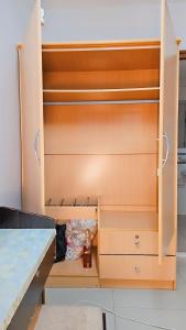 a wooden cupboard with a bottle in it at River View Bangkok in Bangkok