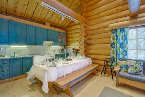 a kitchen with a table in a log cabin at VIP Rakka Villas 7 & 8 in Levi