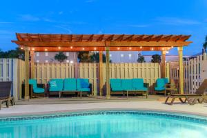 a patio with a gazebo and a pool at Admiral's Inn on Tybee Island in Tybee Island