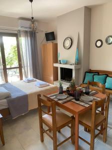 a bedroom with a bed and a table and chairs at Olympia's Seaside Lefokastro in Lefokastro