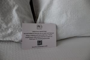 a white pillow with a sign on top of it at ApArte Suite in Râşnov