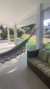 a couch in a living room with a hammock at Gravatá country in Sairé