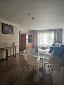 a living room with a table and chairs and a couch at Bedford Family Retreat in Johannesburg
