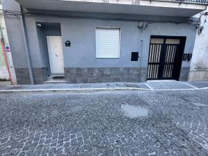 a building with two doors and a cobblestone street at Luxury Sweet Dreams-Napoli in San Vitaliano 