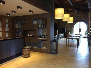 a living room with a fireplace and a dining room at Rocca Di Castagnoli in Gaiole in Chianti