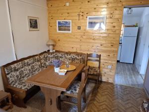 a living room with a couch and a table at Green cottage in Blidinje +60 photos
