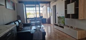 a living room with a blue couch and a tv at apartment tenerife south coast in Costa Del Silencio