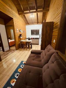 a living room with a couch and a table at Cabanas dos Sonhos 2- Barra de Ibiraquera in Imbituba