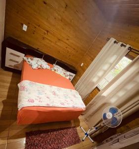 an overhead view of a bed in a room with a fan at Cabanas dos Sonhos 2- Barra de Ibiraquera in Imbituba