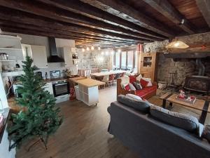 a living room with a christmas tree in the middle at La fruitière in Verchaix