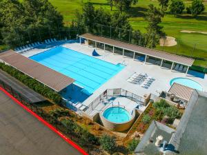 an overhead view of a pool with a tennis court at San Vicente Golf Resort in Ramona