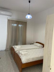 Postel nebo postele na pokoji v ubytování NAFSIKA Apartments